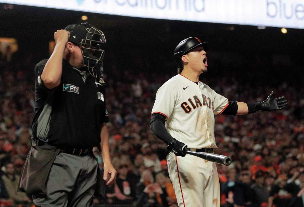 Giants batter Wilmer Flores reacts incredulously after he is called out after his check swing was ruled a strike, making the final out of the game and the series.