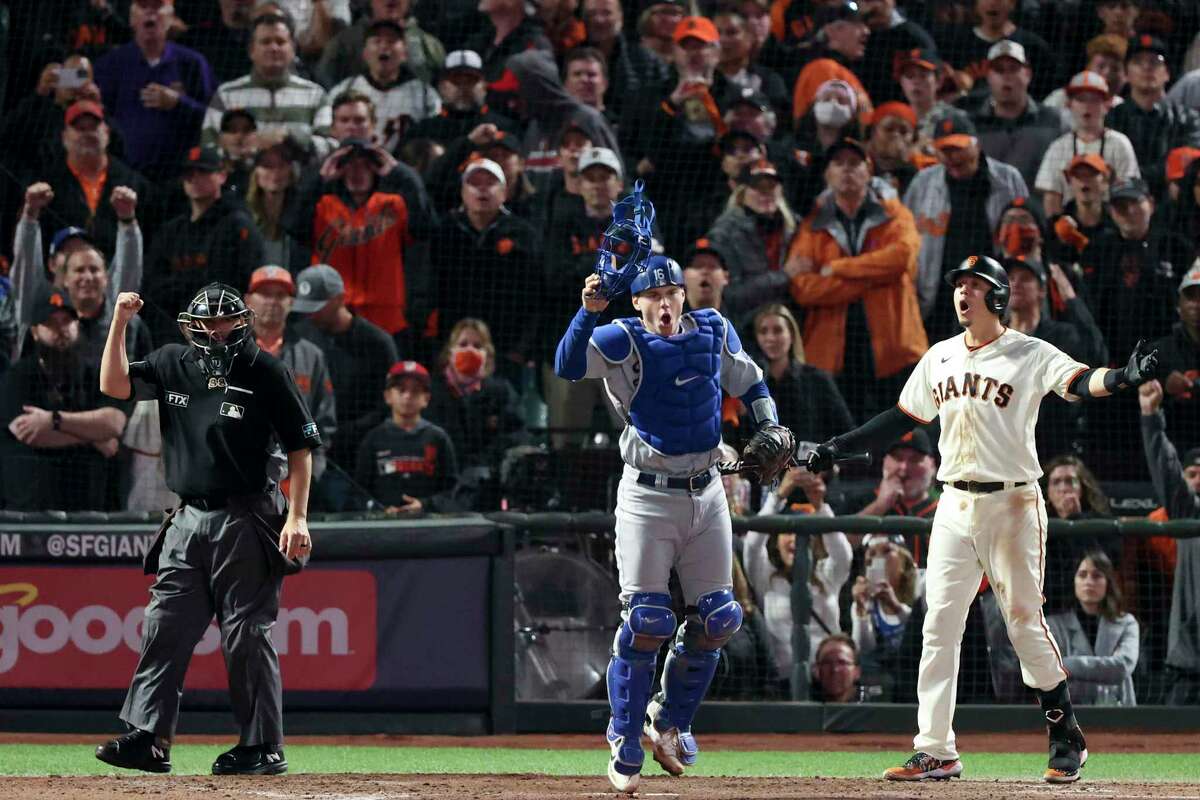 Wilmer Flores of the San Francisco Giants scores against catcher News  Photo - Getty Images