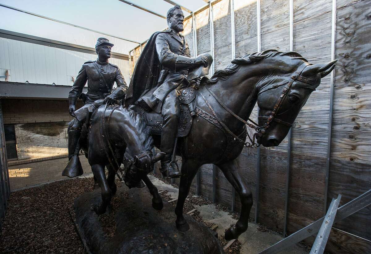FILE - In this Dec. 20, 2018, file photo the 1935 statue of Robert E. Lee, right, and a young soldier by sculptor Alexander Phimister, sit in storage at Hensley Field, the former Naval Air Station on the west side of Mountain Creek Lake in Dallas.The statue was removed from a park in September 2017. (Ashley Landis/The Dallas Morning News via AP, File)/The Dallas Morning News via AP)