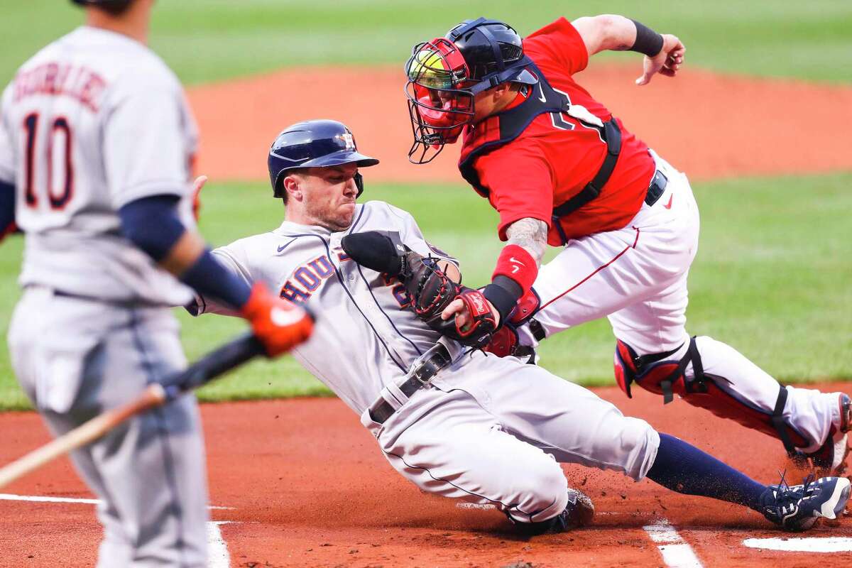 Alex Bregman of the Houston Astros is tagged out at some plate by Christian Vazquez of the Boston Red Sox in the first inning of a game at Fenway Park on June 9.