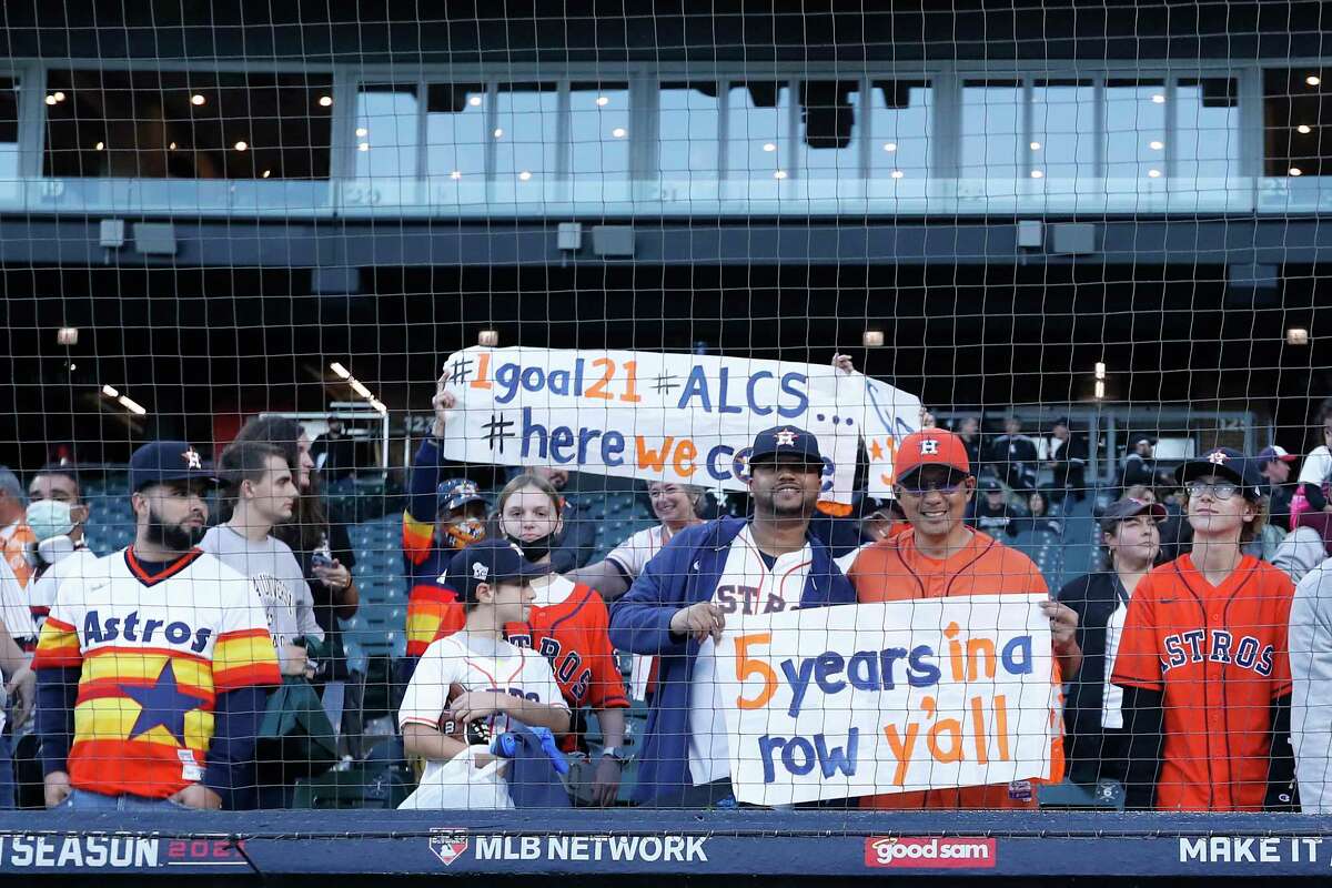 Houston Astros fans celebrate the Astros 10-1 win over the Chicago White Sox in Game 4 to win the American League Division Series Tuesday, Oct. 12, 2021, in Chicago.