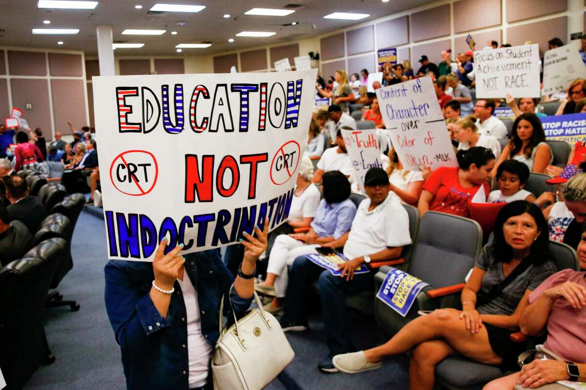Protesters against critical race theory hold signs on Tuesday, June 22, 2021, before the Fort Worth ISD board meeting. (Juan Figueroa/The Dallas Morning News)