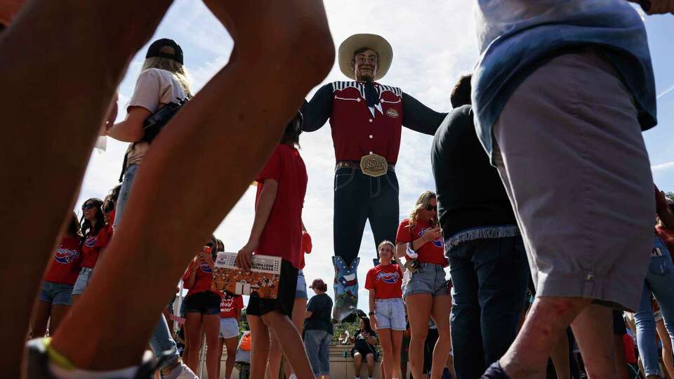 Big Tex towers over fairgoers at the 2021 State Fair of Texas in Dallas. The fair was canceled in 2020 due to the pandemic, making this year's event all that much more anticipated.