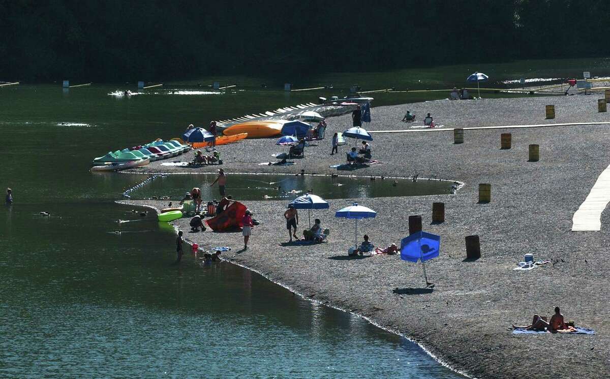 Visitors on Johnson’s Beach enjoy the sun and the Russian River in Guerneville in 2004. The riverfront property with cabins dating to the 1920s and tents has sold to an unknown buyer.