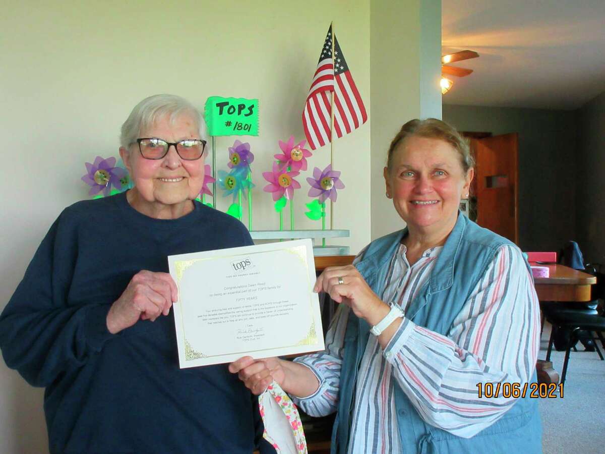 TOPS Club #1801 leader Linda Kiefer (right) presents Dawn Reed of Manistee with a statewide award for 50 years of membership with TOPS Manistee. (Courtesy photo/Mike Tillotson)