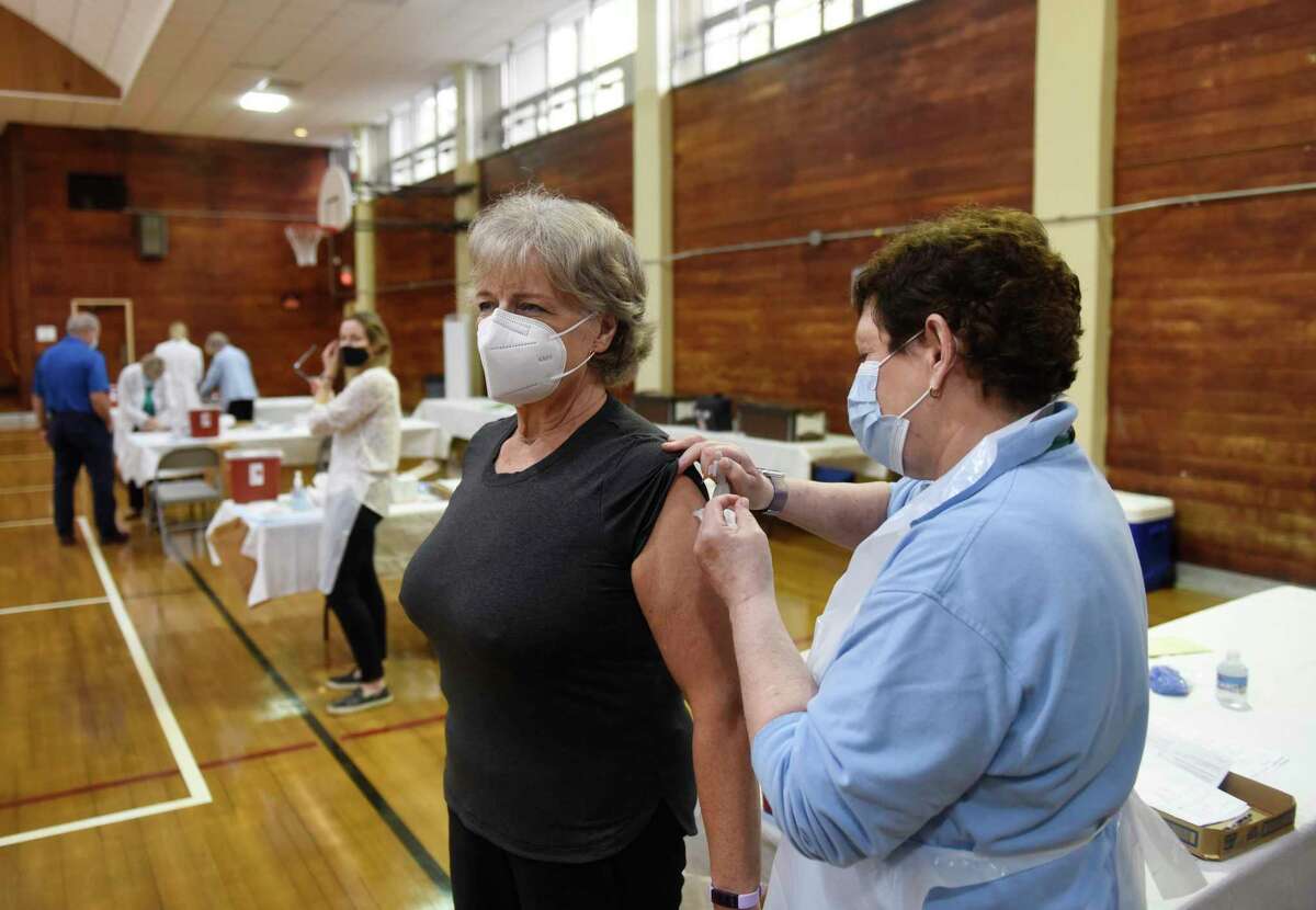 Old Greenwich's Lisa Tebbe gets her flu shot from Lori Liss, RN, at the Greenwich Department of Health Flu Clinic at the Eastern Greenwich Civic Center in Old Greenwich, Conn. Wednesday, Oct. 13, 2021. Flu and pneumonia vaccines were administered to patients age 9 and up at the clinic. The next clinic will be held at Town Hall on Monday, Oct. 18 from 2 p.m. to 5 p.m.