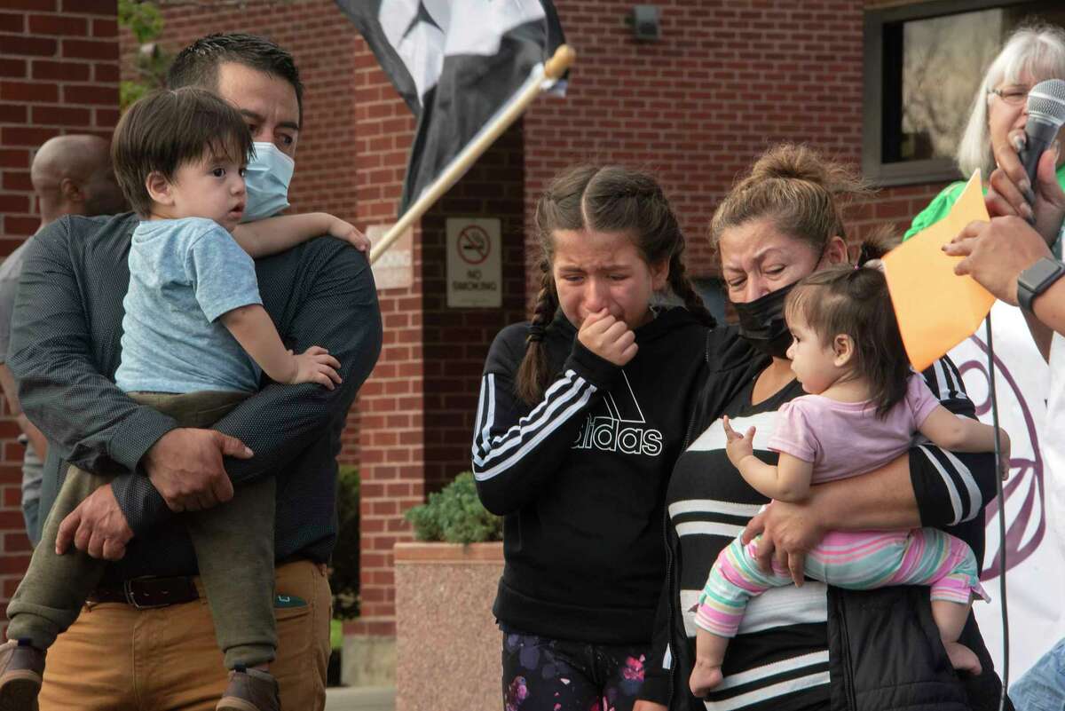 Ten-year-old Michaela cries with her family as her mother, Marisol, of Carmel speaks during a rally of immigration advocates protesting the living conditions and medical neglect they say ICE detainees held at Rensselaer County Jail endure on Friday, Oct, 15, 2021 in Troy, N.Y. Marisol’s sister, who is going by Ms. Q, is detained in the jail. The Times Union withholding the family's last names to protect their privacy and the sister's identity. The protestors gathered in Taras Shevchenko Park and marched to Rensselaer County Jail.