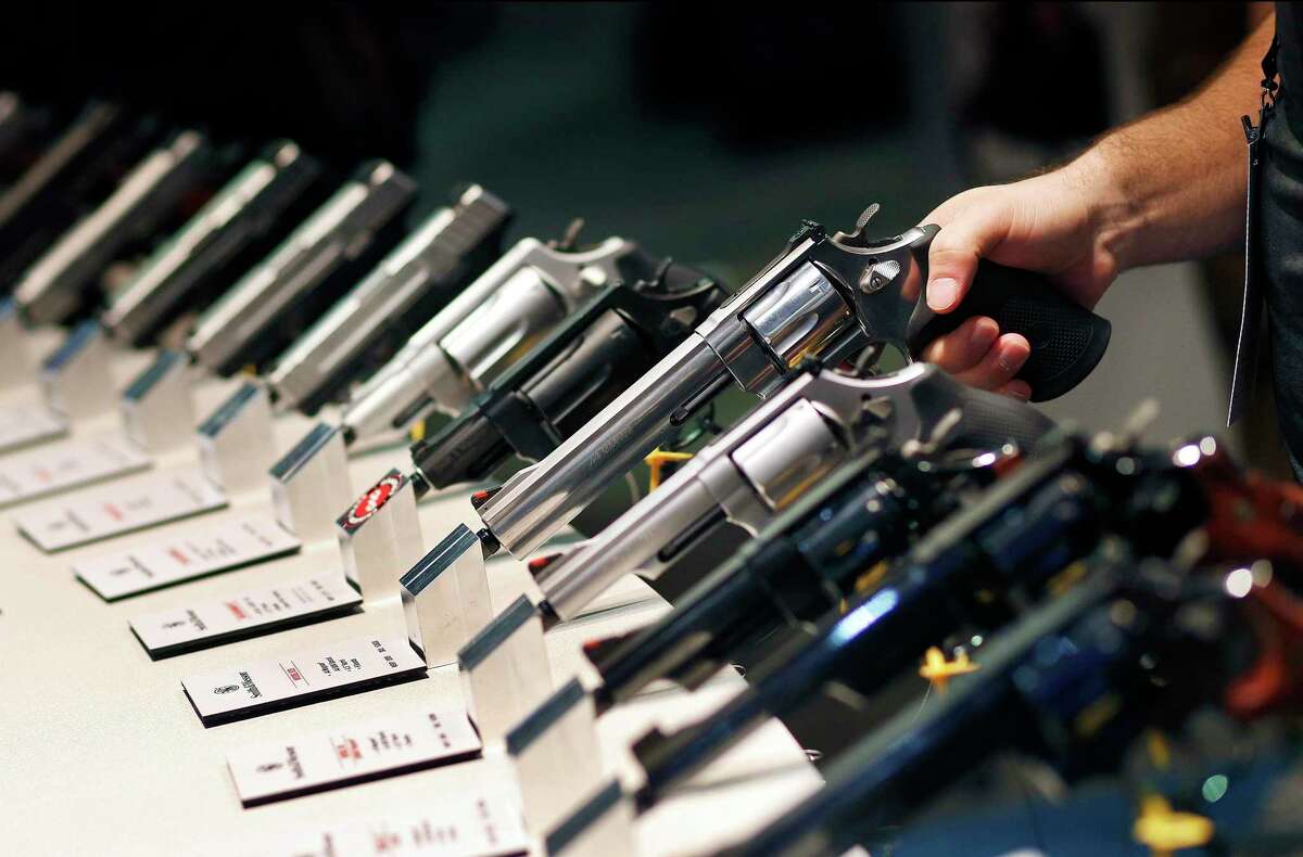 FILE - In this Jan. 19, 2016 file photo, handguns are displayed at the Smith & Wesson booth at the Shooting, Hunting and Outdoor Trade Show in Las Vegas. (AP Photo/John Locher, File)