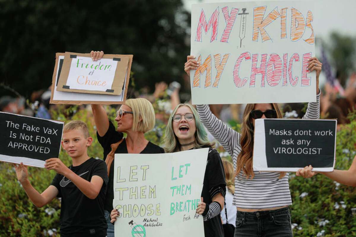 Anti-vaccine protesters stage a demonstration outside the San Diego Unified School District’s offices on Sept. 28.