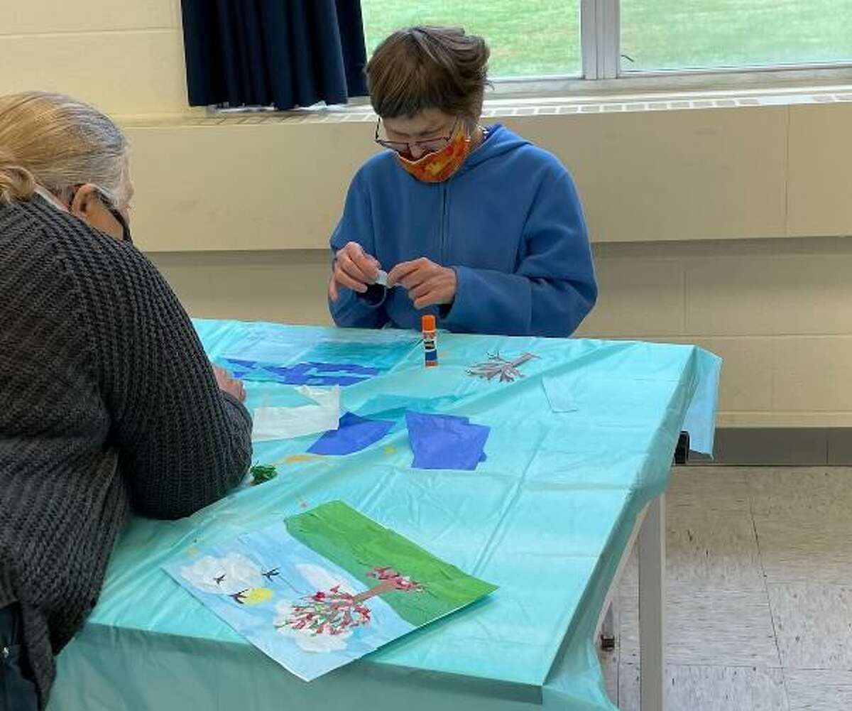 LARC in Torrington recently received a grant for art classes, which are being held at the Five Points Visual Arts Center. Above, Noel Croce, left, works with a student from LARC during a recent class.