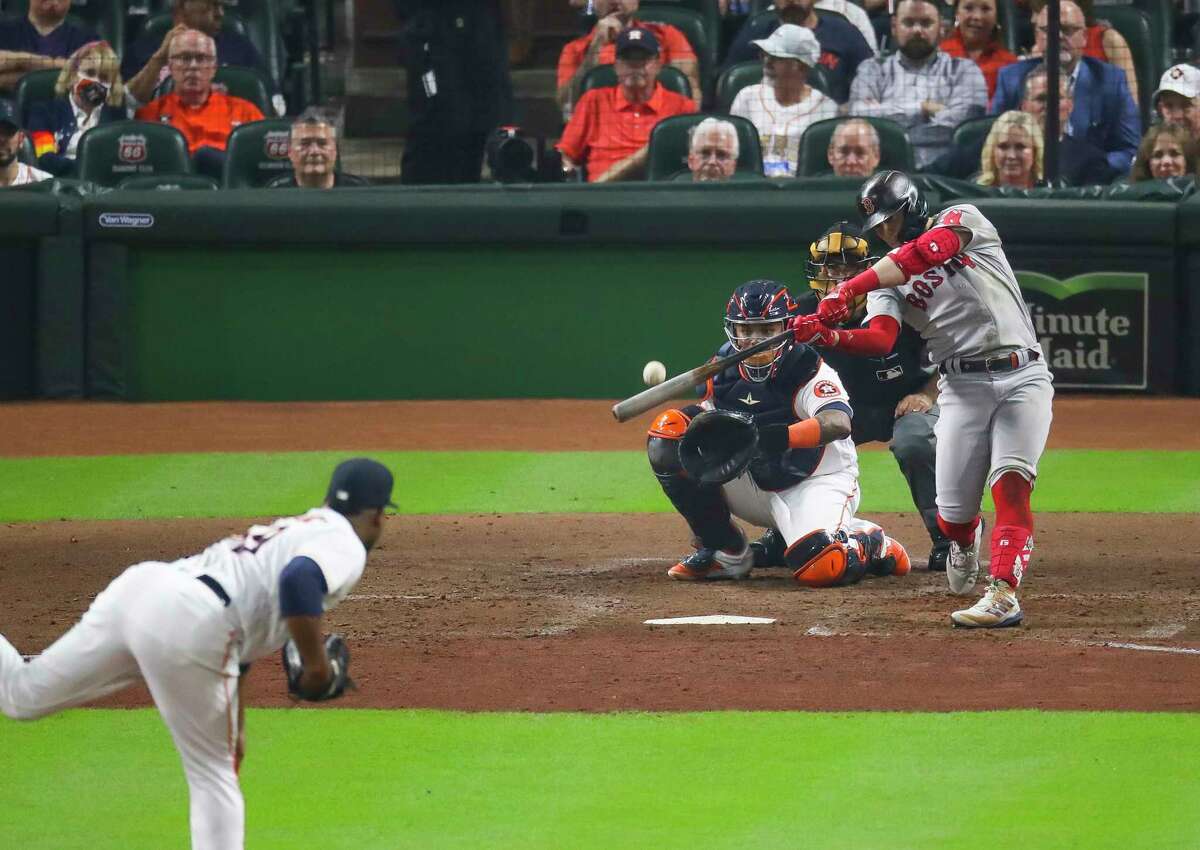 Boston Red Sox center fielder Kike Hernandez (5) hits a game-tying solo home run to start the third inning in Game 1 of the American League Championship Series on Friday, Oct. 15, 2021, at Minute Maid Park in Houston.