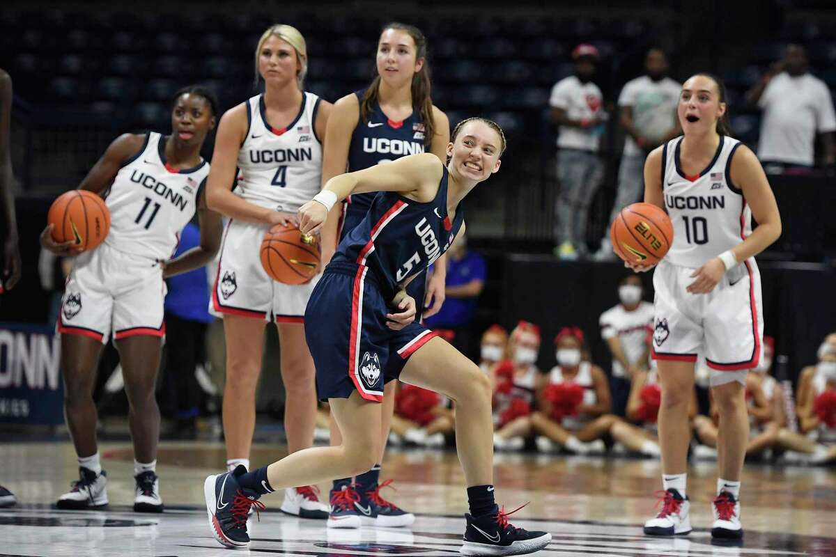 Connecticut's Paige Bueckers reacts after a shot from half-court during First Night events for the UConn men's and women's NCAA college basketball teams Friday, Oct. 15, 2021, in Storrs, Conn. (AP Photo/Jessica Hill)