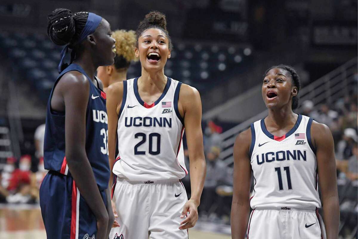 Connecticut's Piath Gabriel, left, Olivia Nelson-Ododa and Mir McLean, right, laugh during First Night events for the UConn men's and women's NCAA college basketball teams Friday, Oct. 15, 2021, in Storrs, Conn. (AP Photo/Jessica Hill)