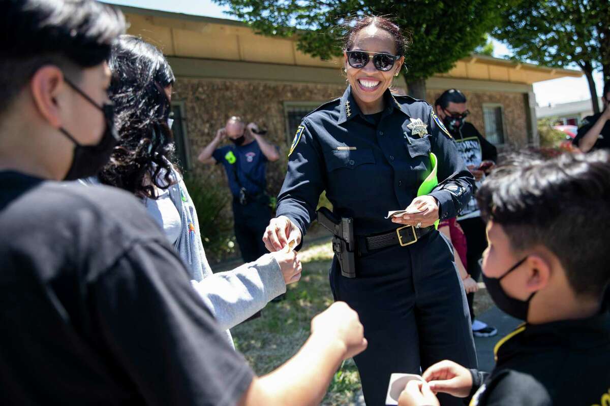 Richmond Police Chief Bisa French hands stickers out to local kids at an event promoting street safety for students in June.