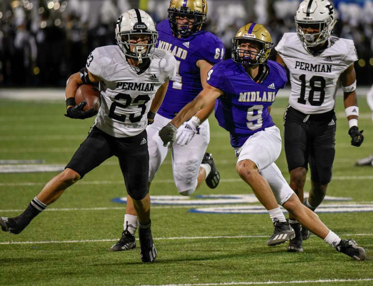 Permian’s Justyce Lara (23) runs the ball as Midland High’s Cade Williams (9) approaches to try to tackle Friday, Oct. 15, 2021 at Grande Communications Stadium. Jacy Lewis/Reporter-Telegram