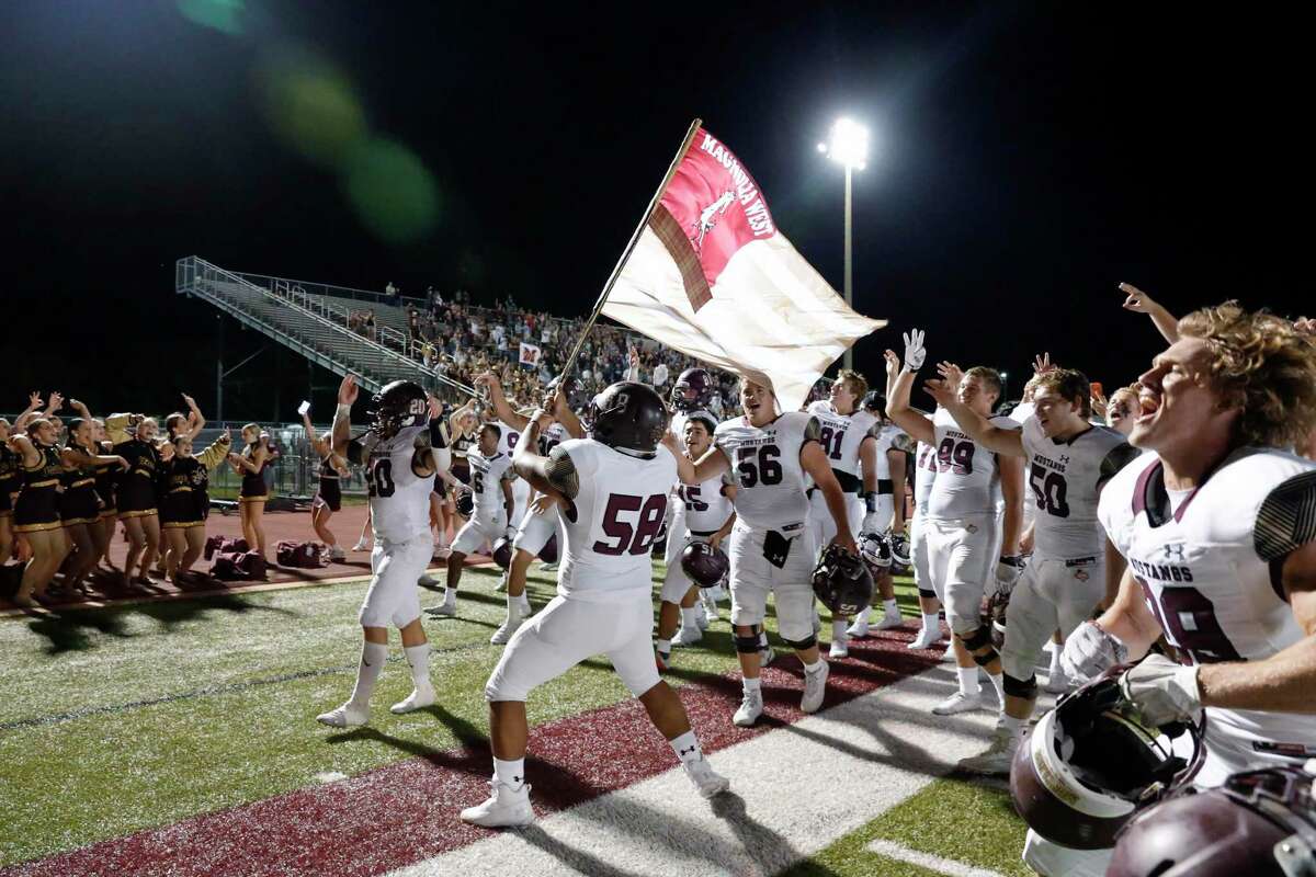 Magnolia West players celebrate after their 21-14 win over Magnolia in their District 8 5A, D1 high school football game at Bulldog Stadium Friday, Oct. 15, 2021 in Magnolia, TX.