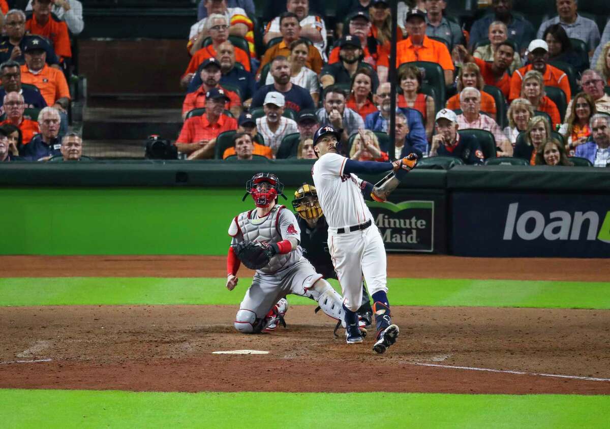 Houston Astros shortstop Carlos Correa (1) hits a solo home run to give the Astros a 4-3 lead during the seventh inning in Game 1 of the American League Championship Series on Friday, Oct. 15, 2021, at Minute Maid Park in Houston.