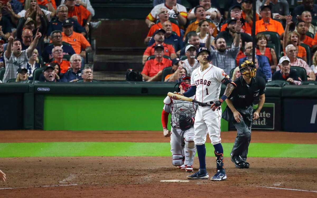 Houston Astros shortstop Carlos Correa (1) watches his solo home run fly over the left field wall into the Crawford Boxes to give the Astros a 4-3 lead during the seventh inning in Game 1 of the American League Championship Series on Friday, Oct. 15, 2021, at Minute Maid Park in Houston.