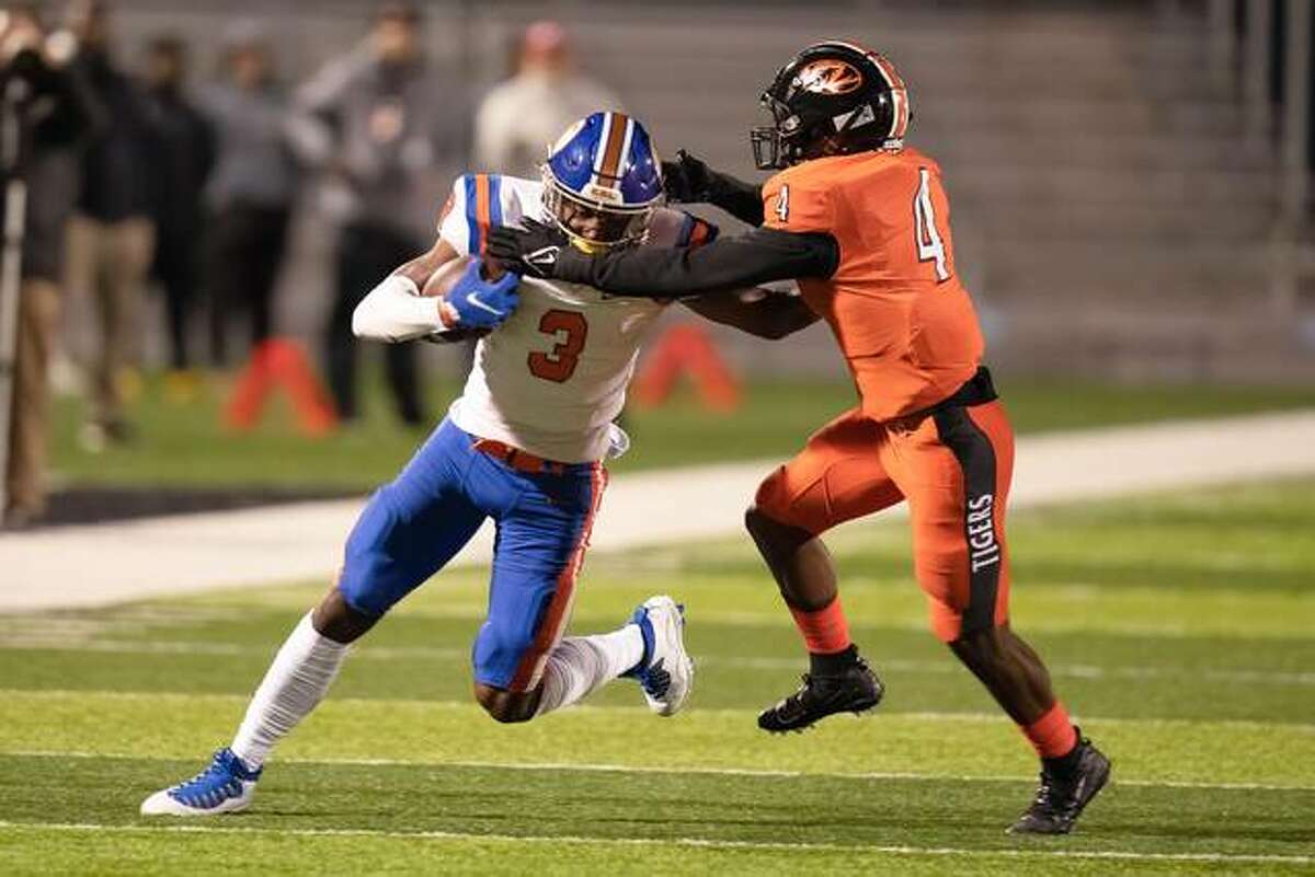 Edwardsville’s Kellen Brnfre attempts to tackle East St. Louis wide receiver Luther Burden III on Friday inside the District 7 Sports Complex.