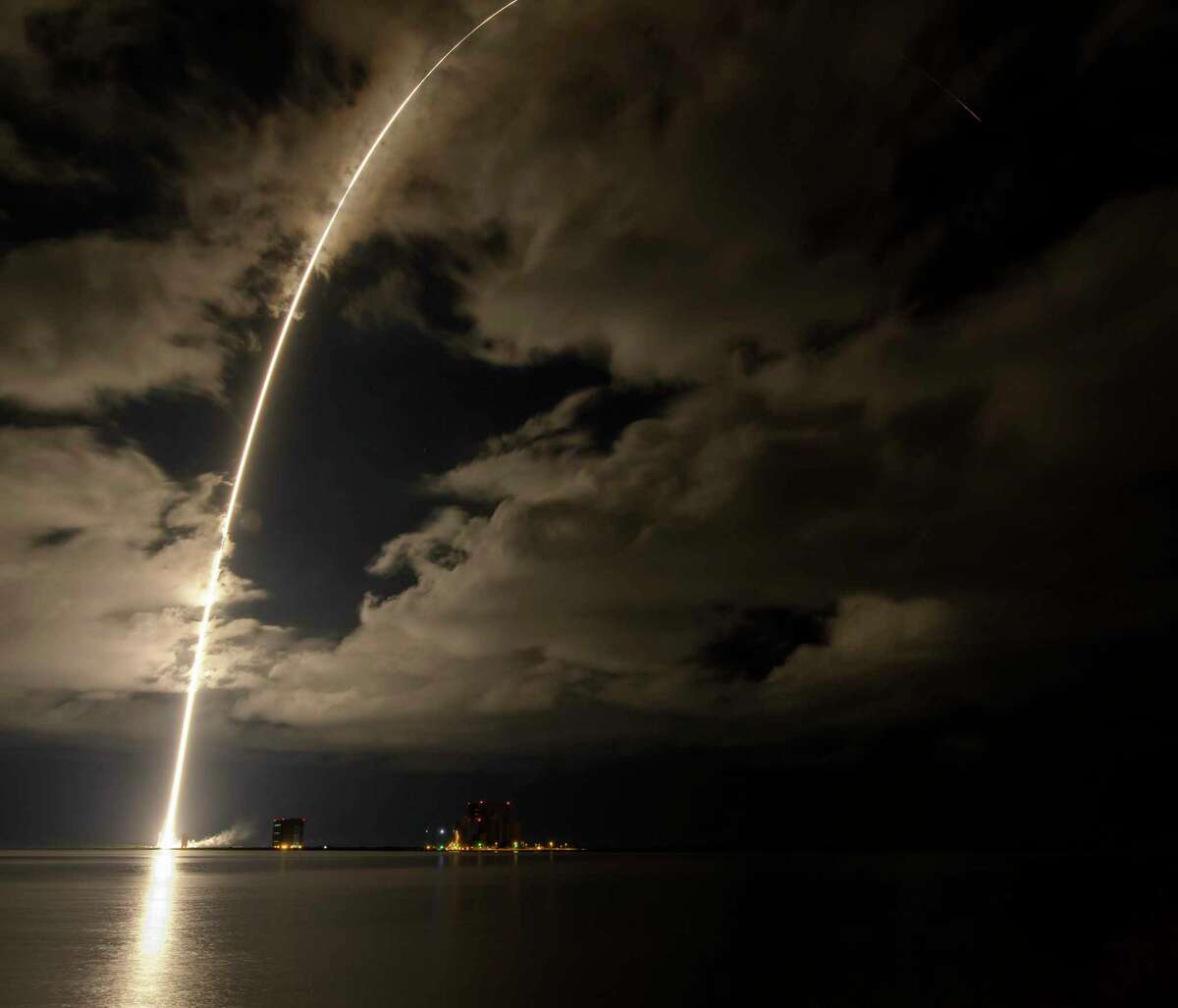 This photo released by NASA, shows a United Launch Alliance Atlas V rocket with the Lucy spacecraft aboard in this 2 minute and 30 second exposure photo as it launches from Space Launch Complex 41, Saturday, Oct. 16, 2021, at Cape Canaveral Space Force Station in Florida. Lucy will be the first spacecraft to study Jupiter's Trojan Asteroids. Like the mission's namesake - the fossilized human ancestor, "Lucy," whose skeleton provided unique insight into humanity's evolution - Lucy will revolutionize our knowledge of planetary origins and the formation of the solar system. (Bill Ingalls/NASA via AP)