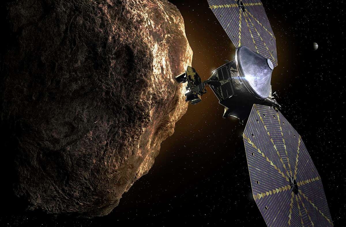 An undated image from NASA and Lockheed Martin shows an artistÕs conception of the Lucy spacecraft encountering a a Trojan asteroid. In a vast odyssey across the solar system, NASAÕs Lucy probe will study Trojan asteroids, which may contain secrets of how the planets ended up in their current orbits. (NASA/Lockheed Martin via The New York Times) Ñ FOR EDITORIAL USE ONLY Ñ