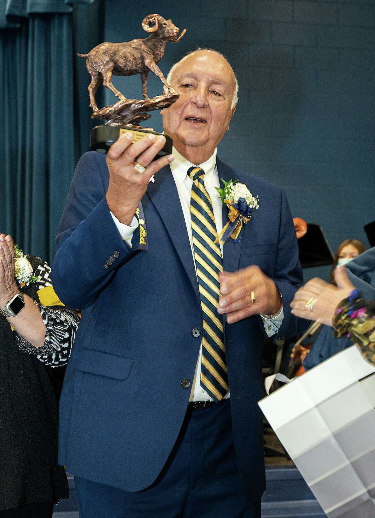 Former UISD Superintendent Robert J. Santos is gift a statuette of a ram, the mascot of Robert J. Santos Elementary School, Friday, Oct. 15, 2021, during a dedication ceremony for the school.