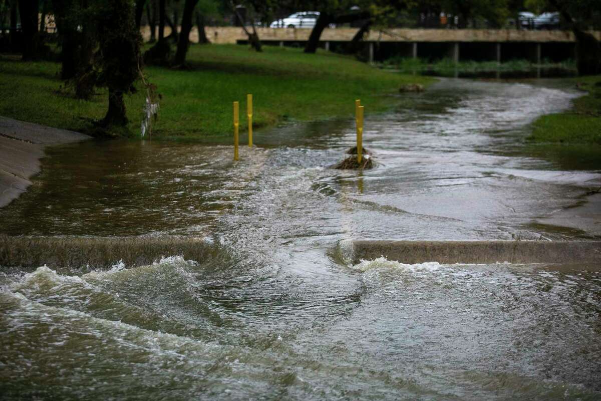 A swollen creek after rainfall the night before, flows over a pedestrian path at Raymond Rimkus Park in Leon Valley, Texas, on Thursday, Oct. 14, 2021. The former Hurricane Pamela swept through the area Wednesday night into Thursday morning, dropping as much as 8 inches of rain.