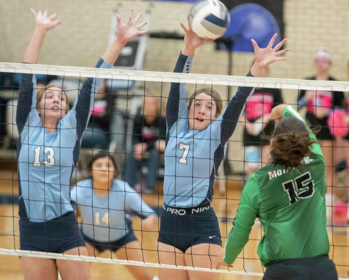 Greenwood's Kate Crunk and Kirklyn Smith go up for the block as Monahans' Katilyn Alvarez tries to get it past 10/16/2021 at Greenwood High School. Tim Fischer/Reporter-Telegram