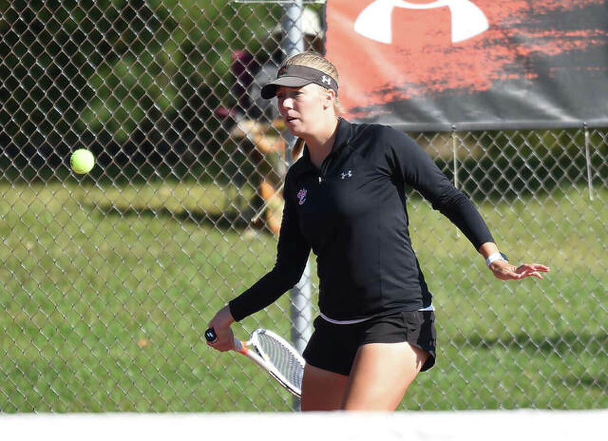 Edwardsville’s Hannah Colbert prepares to hit a shot during her doubles match at the Edwardsville Sectional on Saturday inside the EHS Tennis Center.