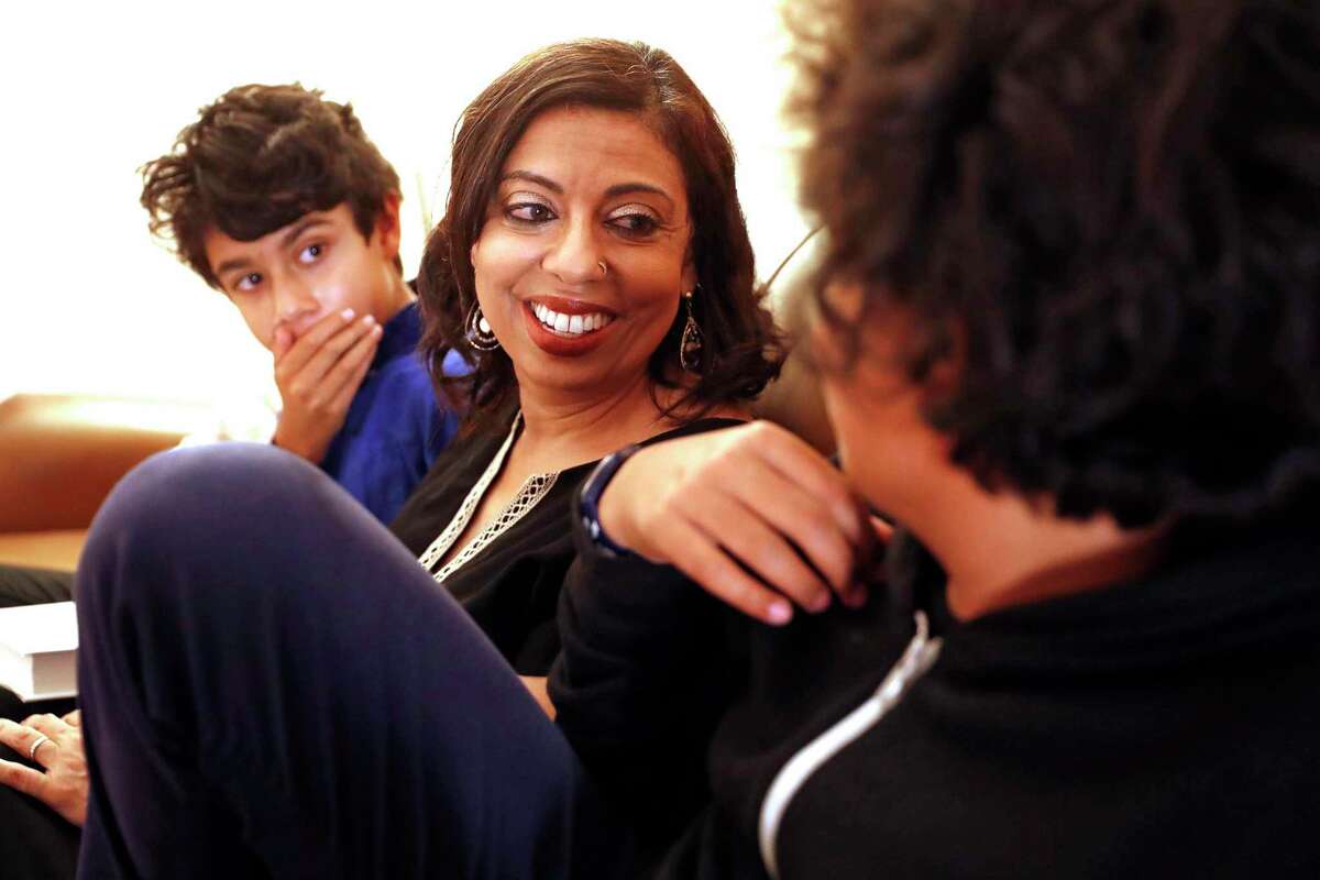 Dr. Monica Gandhi chats with her sons, Vedant Mishra (left) and Ishaan Mishra, at their home.