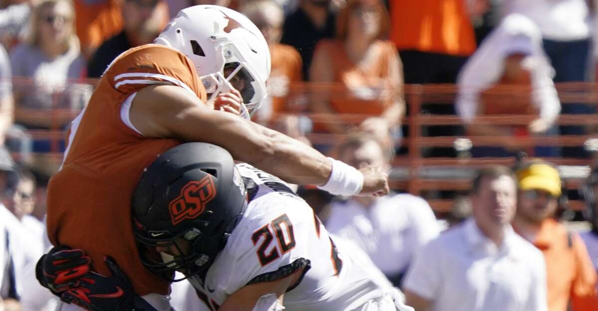 Oklahoma State linebacker Malcolm Rodriguez (20) hits Texas quarterback Casey Thompson (11) after his pass during the second half of an NCAA college football game in Austin, Texas, Saturday, Oct. 16, 2021. (AP Photo/Chuck Burton)