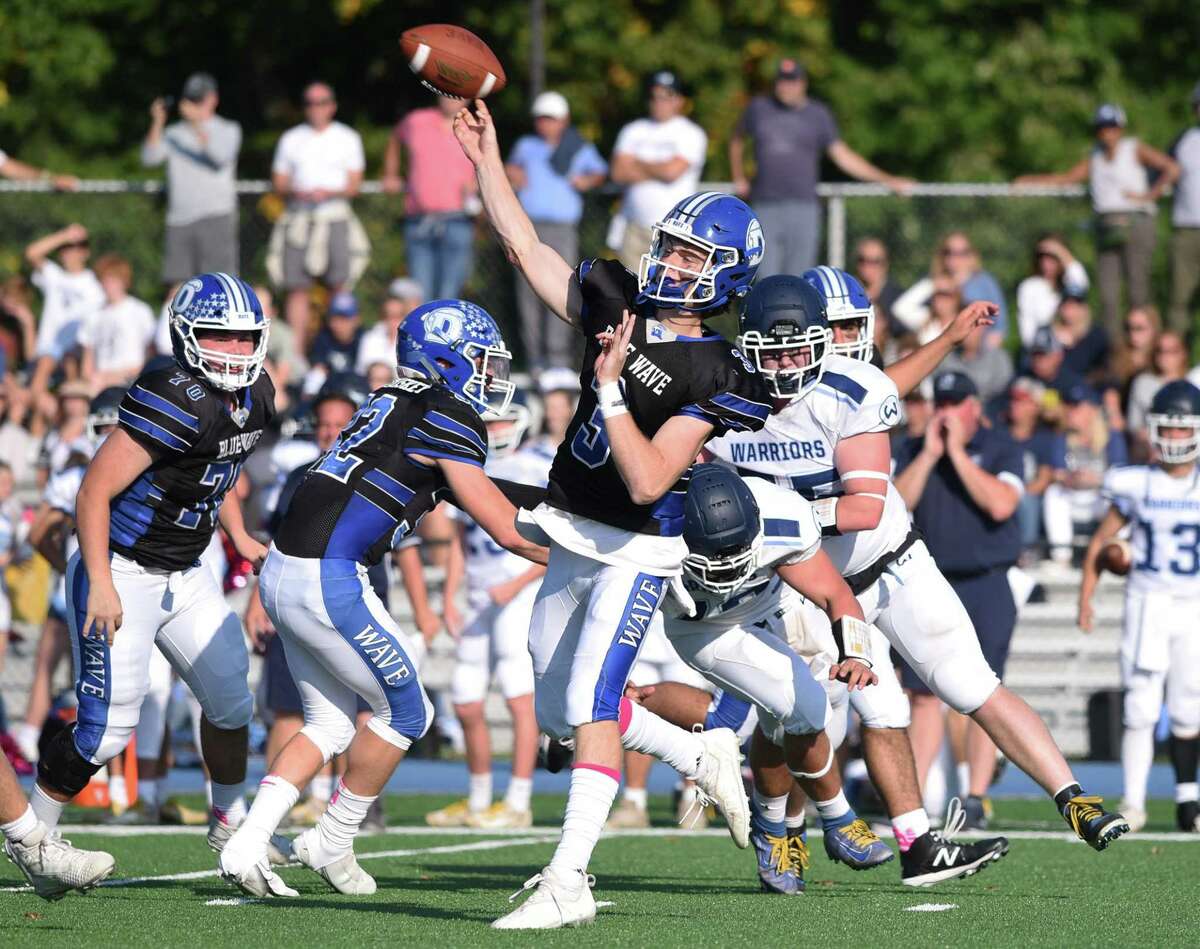 Darien quarterback Miles Drake (3) throws a pass against Wilton on Saturday. Darien is one of the 16 undefeated teams in the state.