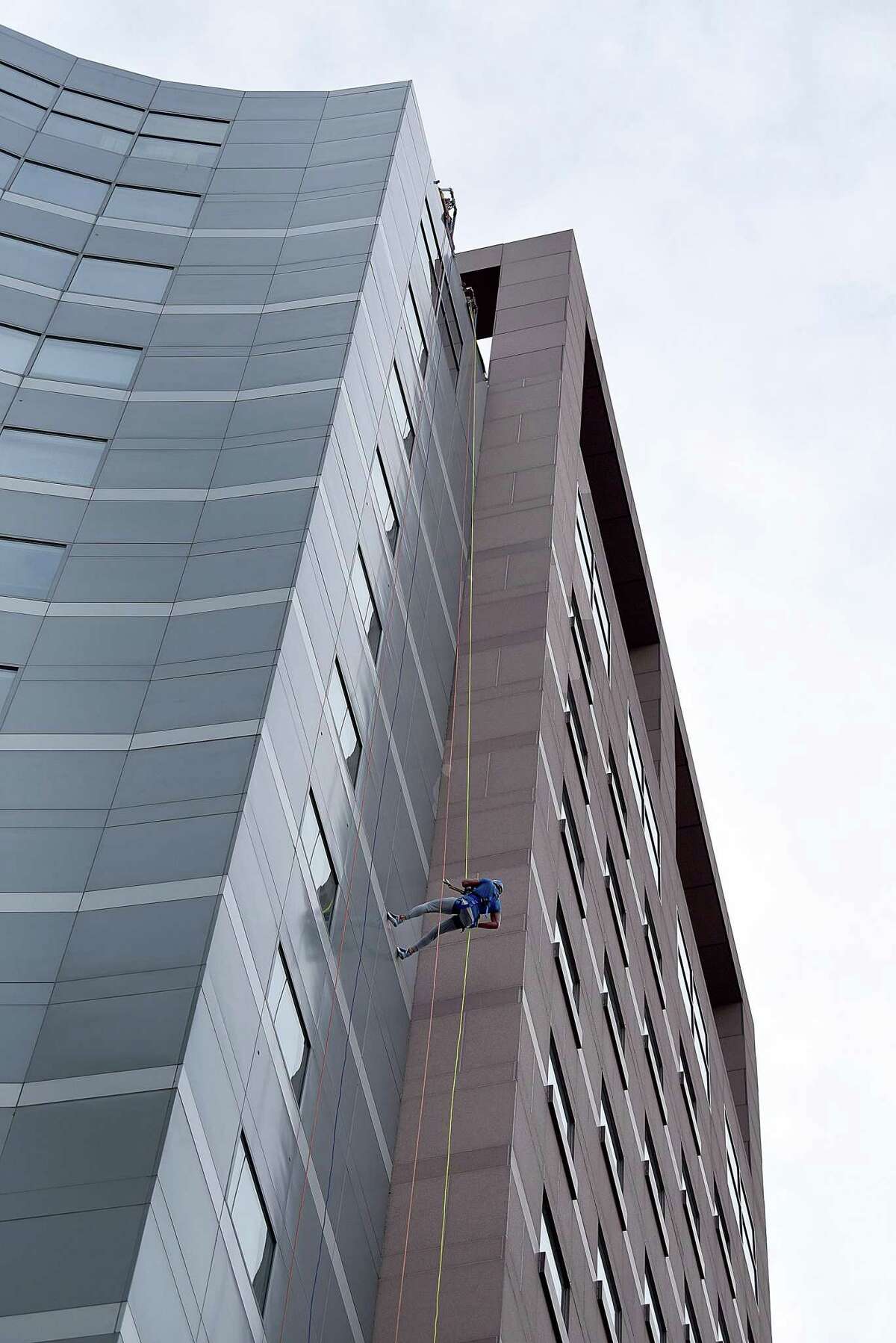Jeff Webster of Monroe rapells from the top of the People’s United Bank building in Bridgeport Saturday, Oct. 16, 2021. The event was a fundraising effort for Wakeman’s Boys and Girls Club in Southport held in conjunction with Over the Edge.
