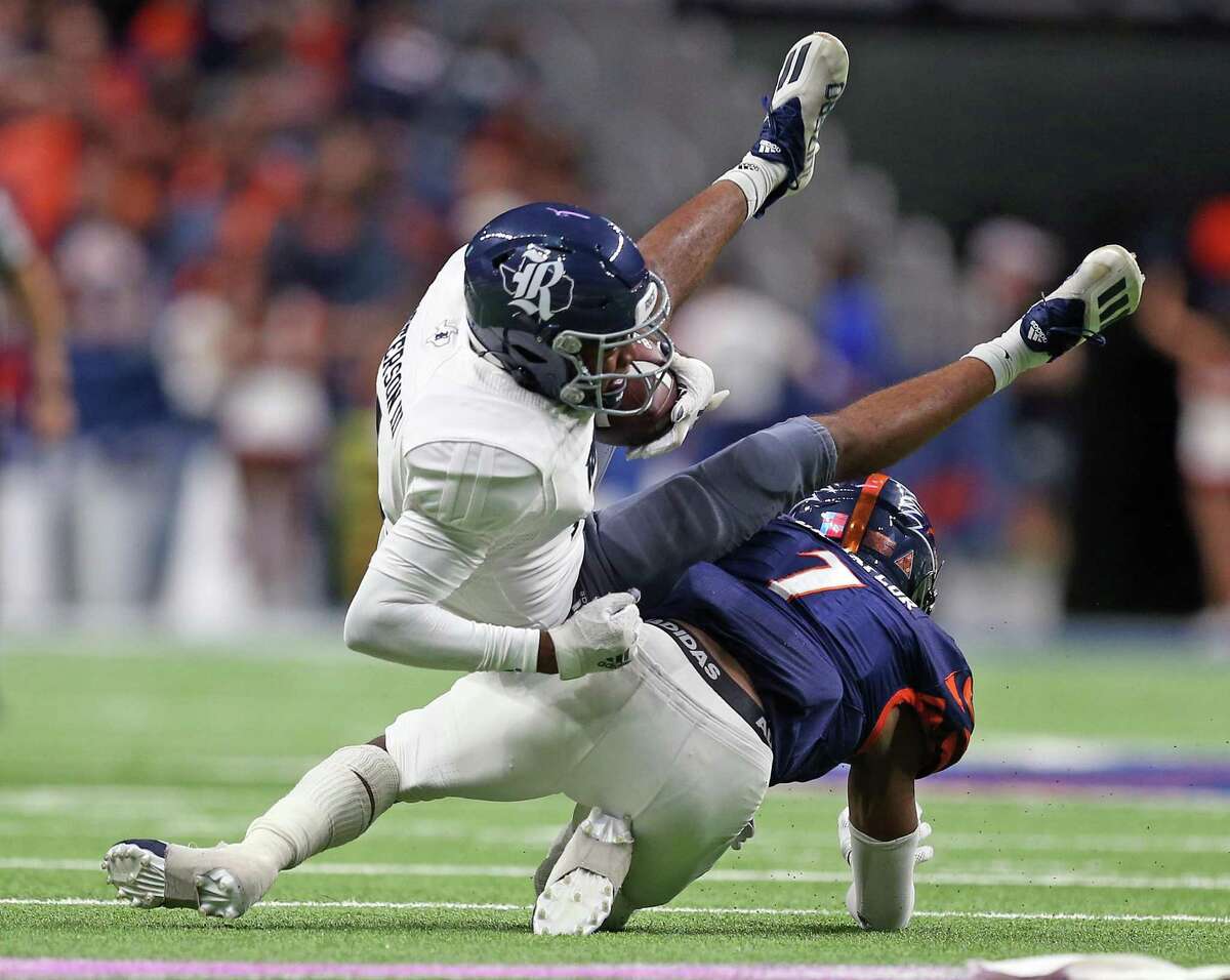 Rice wide receiver Cedric Patterson is upended by UTSA linebacker Dadrian Taylor (7). UTSA defeated Rice 45-0 on Saturday, Oct. 16, 2021 at the Alamodome.