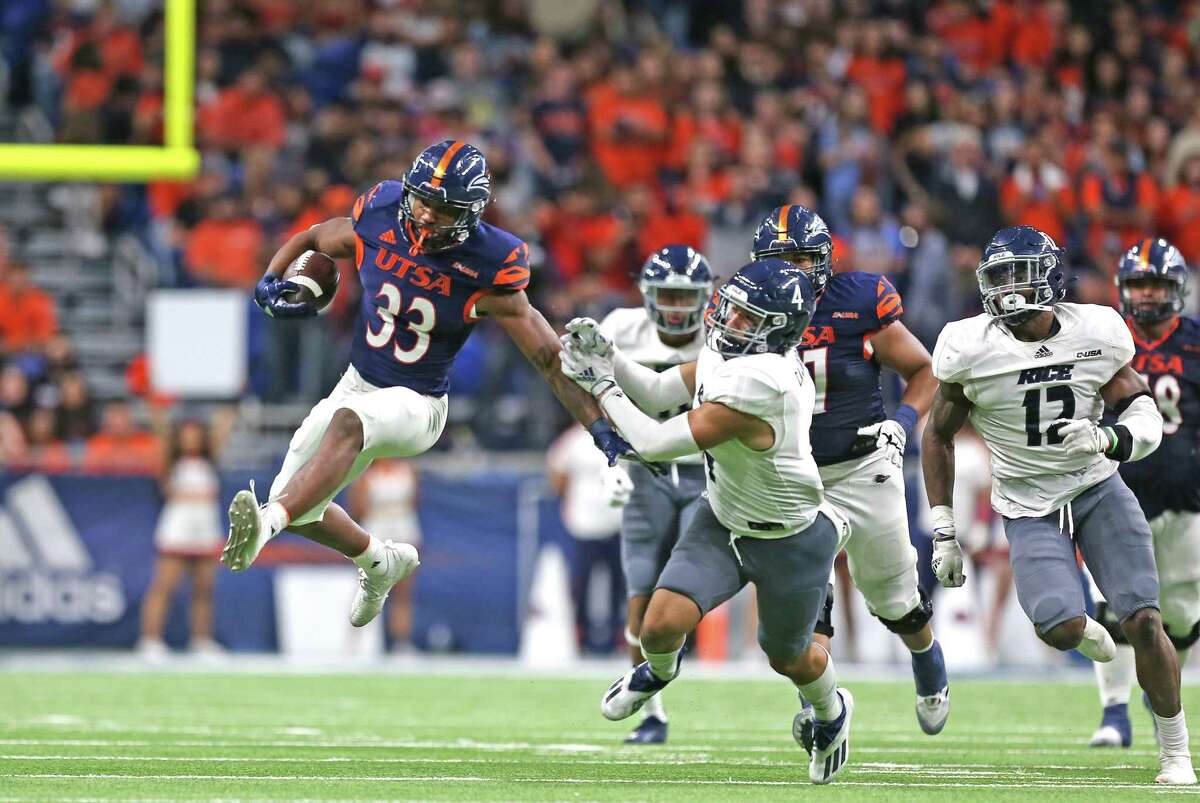 UTSA running back B.J. Daniels (33) leaps out of the grasp of would be Rice tackler. UTSA defeated Rice 45-0 on Saturday, Oct. 16, 2021 at the Alamodome.