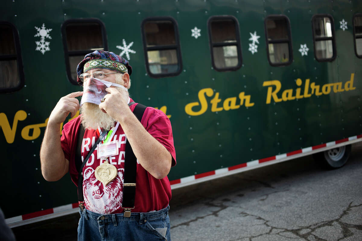 David Reager of Pennsylvania chats with another participant of the Charles W. Howard Santa School as they check out the Northern Star Railroad train Saturday, Oct. 16, 2021 at Gerace Construction in Midland. (Katy Kildee/kkildee@mdn.net)