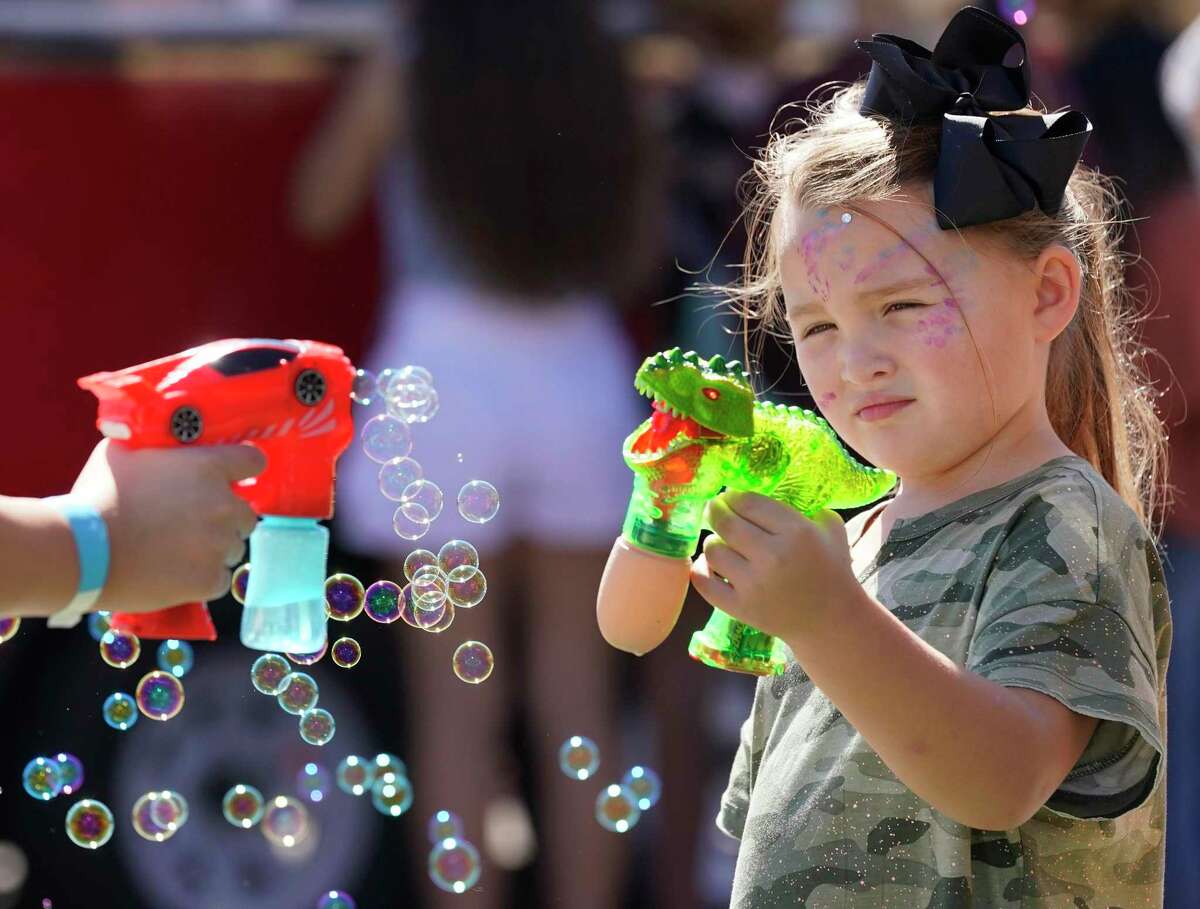 River Cowart, 5, plays with bubbles during the Montgomery Fall Festival in historic downtown Saturday, Oct. 16, 2021 in Montgomery.