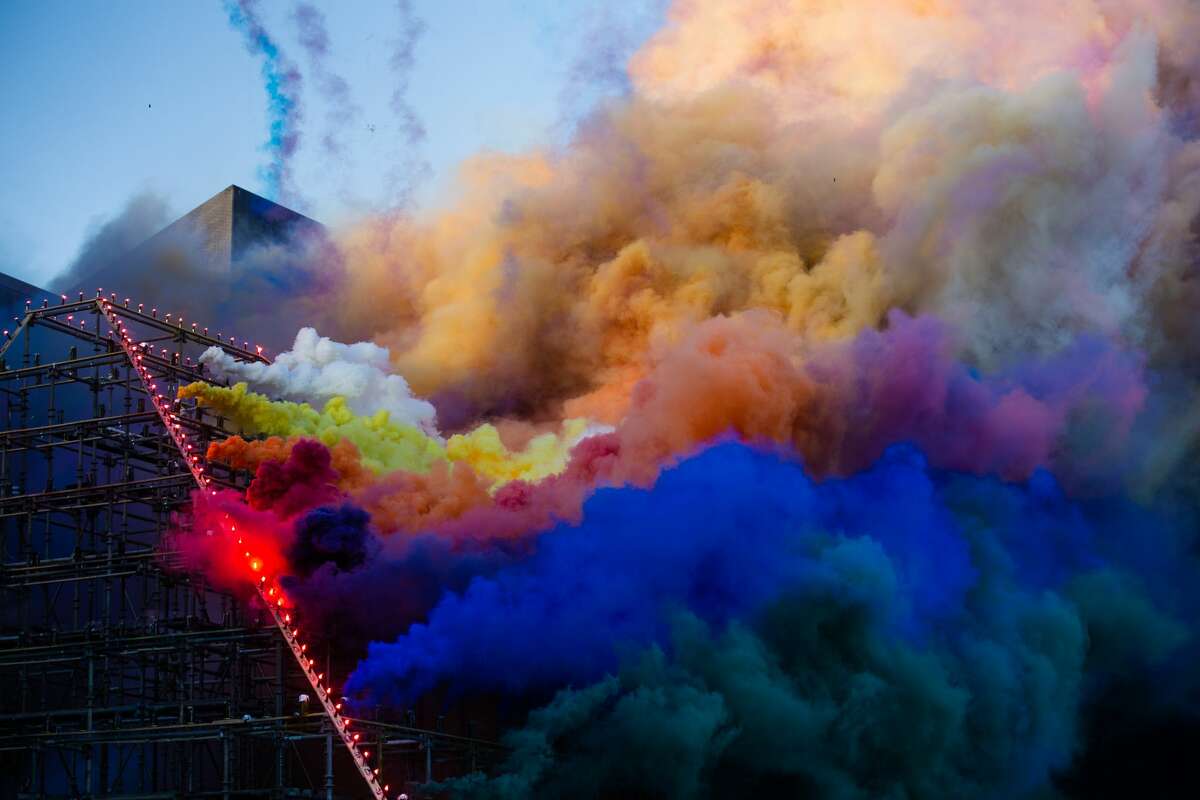 Colorful plumes of smoke rise and drift east across San Francisco during Judy Chicago's Forever de Young installation on October 16, 2021. (Kevin Kelleher / Special to SFGATE)