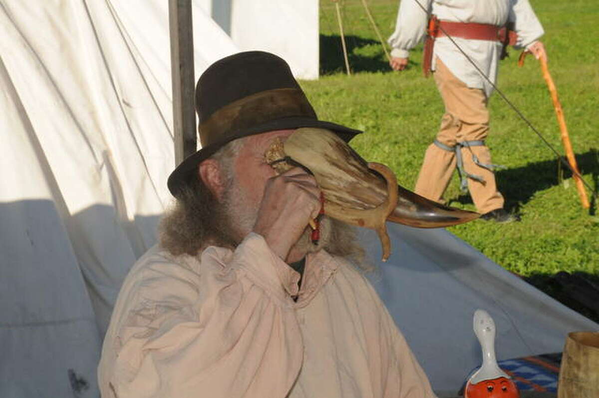 Ray Scott of St. Elmo drinks from a horn during Saturday’s Piasa Free Trappers Rendezvous in Hardin.