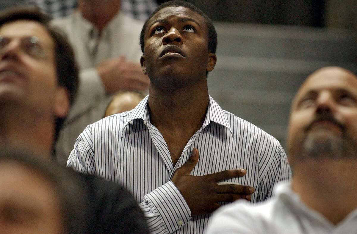 Actor Edwin Hodge, shown attending a 2004 Spurs game during the playing of the national anthem, portrays Joe, an enslaved servant of Alamo commander William Barret Travis, in the 2004 movie, “The Alamo.” Joe survived the battle and escaped bondage more than a year later. But mystery surrounds another person, listed as “John,” who has been desribed as an enslaved store clerk who also was at the Alamo.