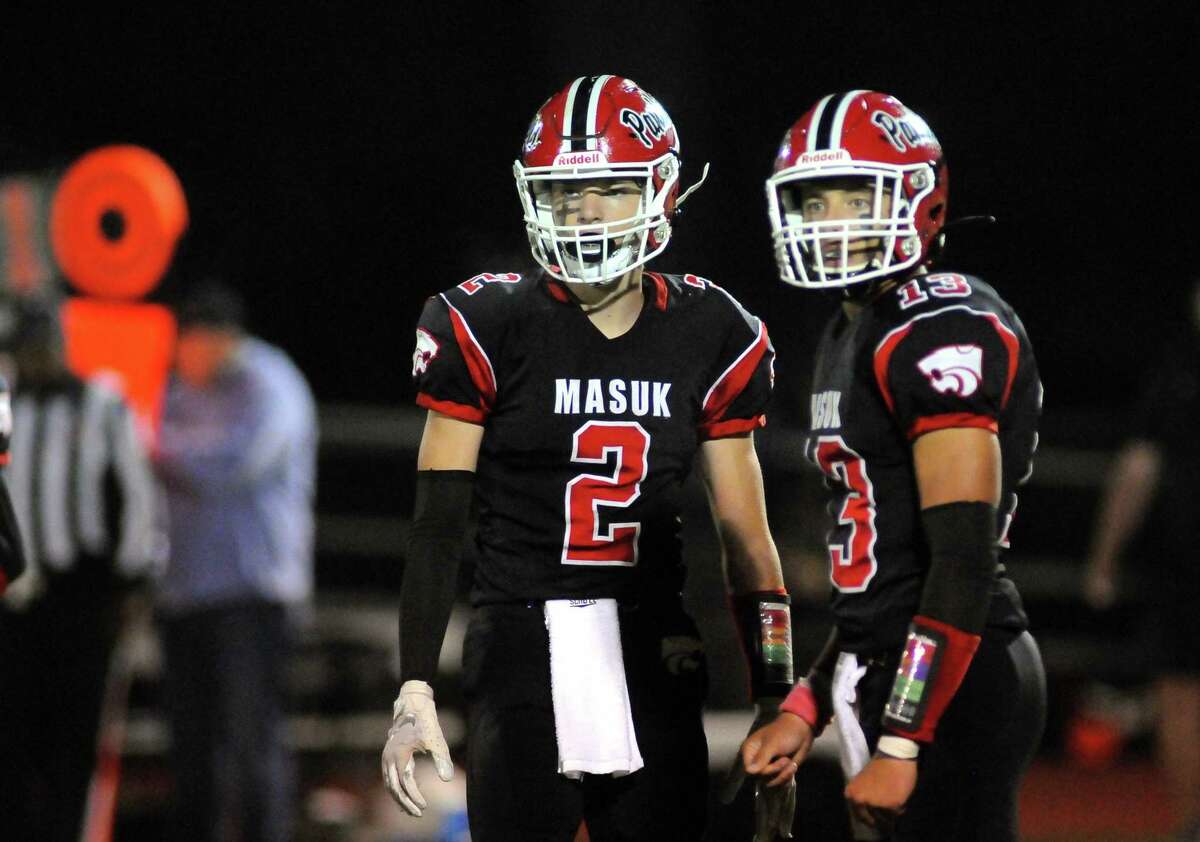 Masuk QB Nicholas Saccu (13) and his twin brother Ryan Saccu (2) on the field during high school football action against Daniel Hand in Monroe, Conn., on Friday October 1, 2021.