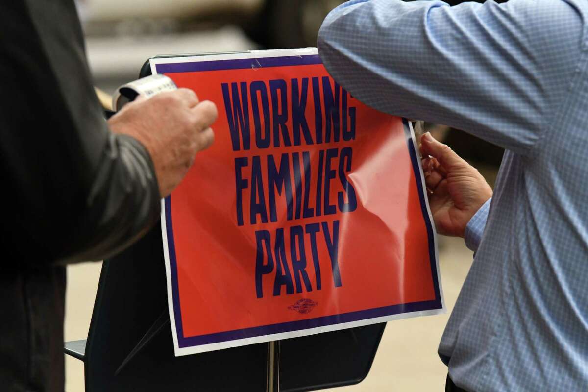 A Working Families Party sign is taped to the podium on Monday, Oct. 18, 2021, during a press conference outside City Hall in Saratoga Springs, N.Y. Working Families Party in Saratoga is annoyed with local GOP efforts to add Republican candidates under their line, which is typically paired with Democrats.