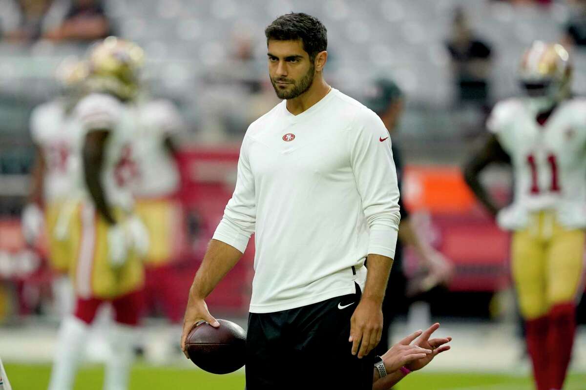 San Francisco 49ers quarterback Jimmy Garoppolo watches warms ups prior to an NFL football game against the Arizona Cardinals, Sunday, Oct. 10, 2021, in Glendale, Ariz. (AP Photo/Darryl Webb)