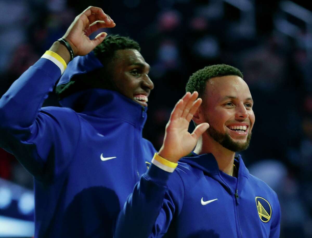Golden State Warriors' Stephen Curry and Kevon Looney before playing Denver Nuggets in 1st quarter during NBA preseason game at Chase Center in San Francisco, Calif., on Wednesday, October 6, 2021.