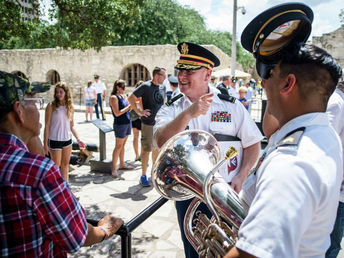 Chief Warrant Officer 4 Jared DeLaney, bandmaster of Fort Sam?•s 323rd Army Band, center, speaks with the family of Sgt. Matthew Viesca, right, after the band performed their Fourth of July concert in Alamo Plaza on Friday, July 2, 2021 in San Antonio, Tx., U.S.