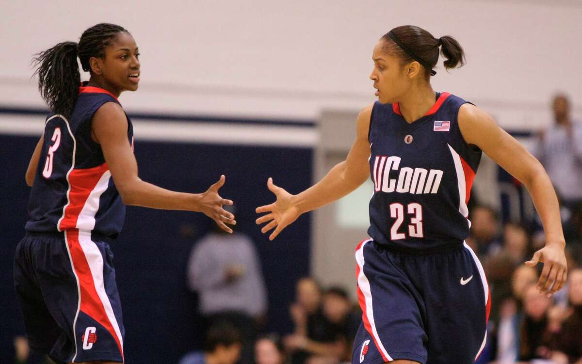 FILE - In this Jan. 31, 2009, file photo, Connecticut's Maya Moore (23) is congratulated by Tiffany Hayes after scoring against Georgetown during the second half of an NCAA college basketball game in Washington. Renee Montgomery and Hayes appreciated what former UConn teammate Moore was doing when the All-Star forward stepped away from basketball two years ago to focus on criminal justice reform. The Atlanta Dream guards admit they weren't sure why she couldn't continue keep playing at the same time. Now they have a better understanding. (AP Photo/Luis M. Alvarez, File)