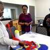 Ruby Chargois shows a work in progress to Caron Tigner (center) and Mary Ellison during crochet class at the Lakeside Center Best Years. The senior center offers a myriad of programs and activities as well as meals Monday through Friday to provide a holistic balance of activities for those 55 and older. Photo made Monday, October 18, 2021 Kim Brent/The Enterprise