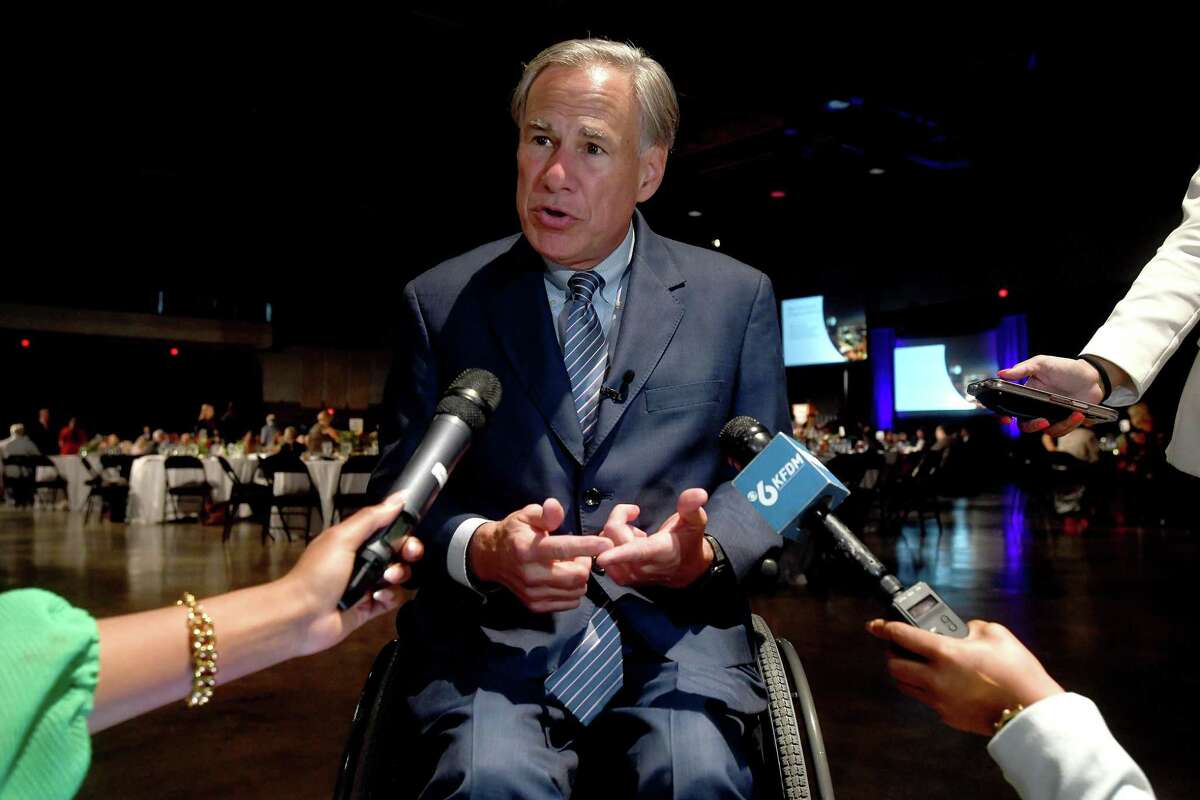 Governor Greg Abbott stops to briefly field questions before taking the stage as the keynote speaker at the annual Beaumont Chamber of Commerce's meeting. Photo made Tuesday, October 12, 2021 Kim Brent/The Enterprise