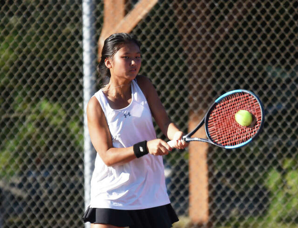 Edwardsville’s Chloe Koons connects on a backhand shot during her singles championship match at the Class 2A Edwardsville Sectional.