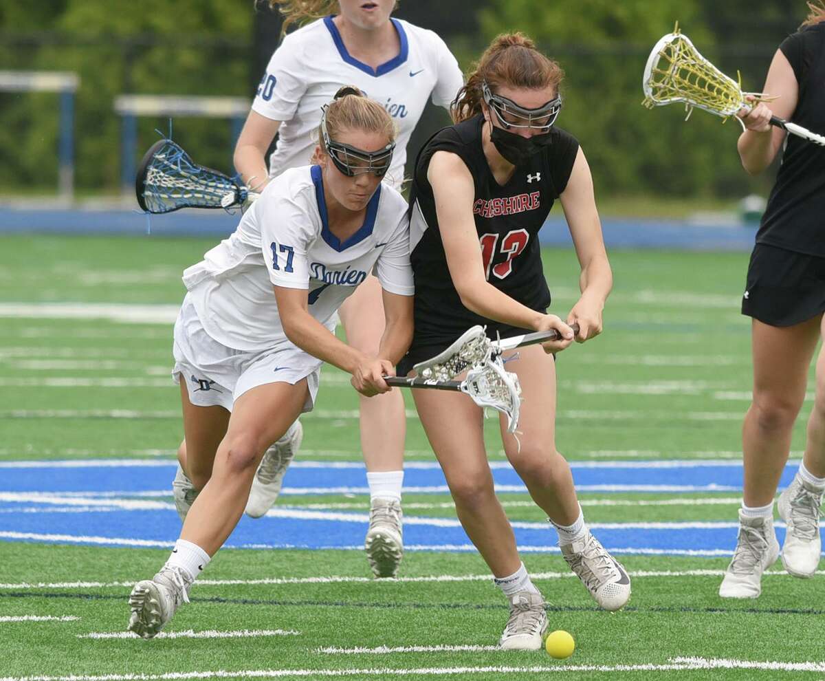 Darien’s Ryan Hapgood (17) and Cheshire’s Taryn Ugrin (13) battle for a groundball during a CIAC Class L girls lacrosse quarterfinal game in Darien on June 4. Hapgood was part of an U-18 team that swept through the Fall Classic in Maryland this past weekend.